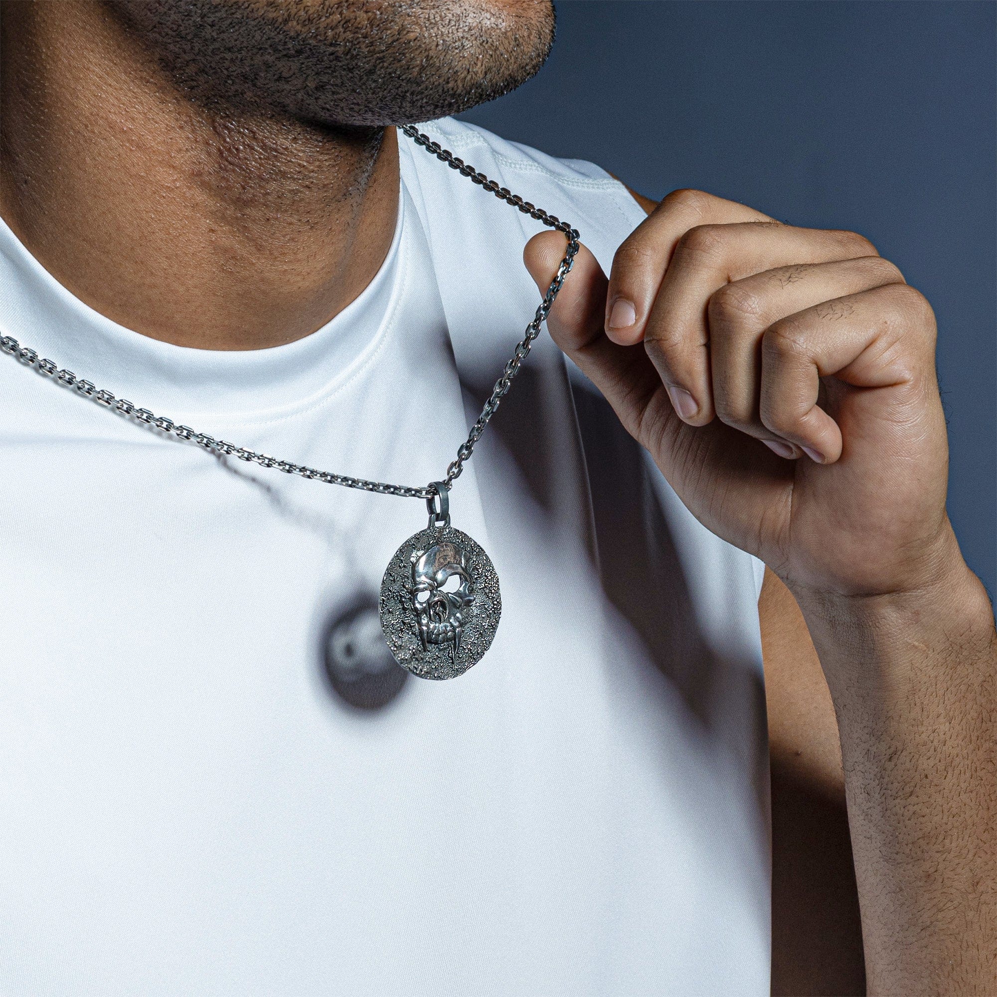 Helm Oxidized Silver Skull Pendant on Dark Textured Surface