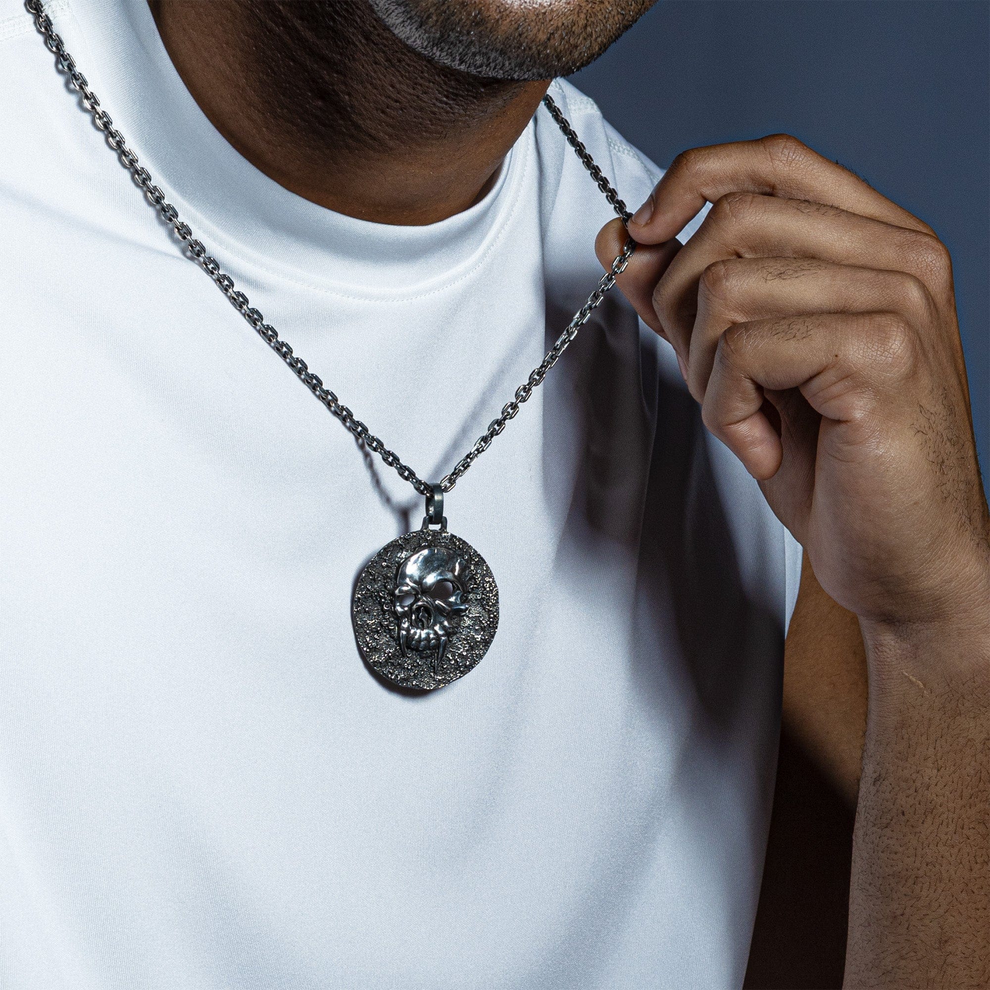 Helm Oxidized Silver Skull Pendant on Dark Textured Surface